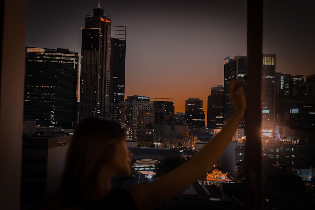 A person stands inside a modern home looking out a large, clean window at the city below, symbolizing gaining clarity on home equity.