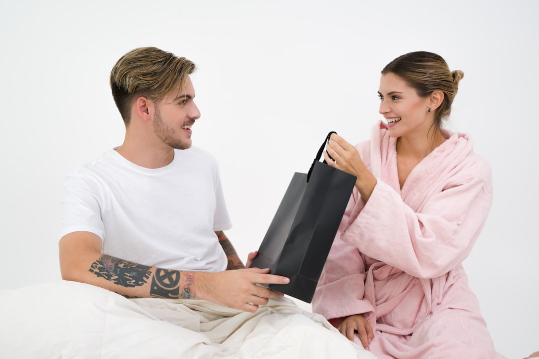 A smiling couple sits at a bright, minimalist dining table, looking confidently at paperwork, symbolizing a smart financial decision about their home equity.