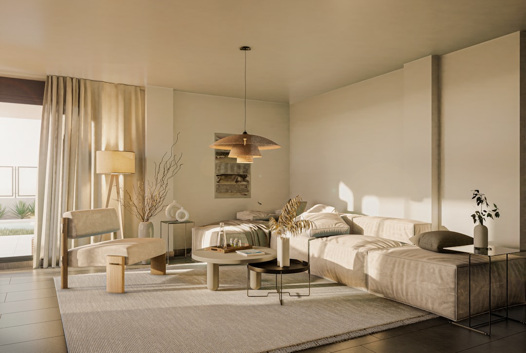 Sunlight streams through the windows of a bright, modern, and minimal living room, evoking a sense of calm, clarity, and high-value real estate.