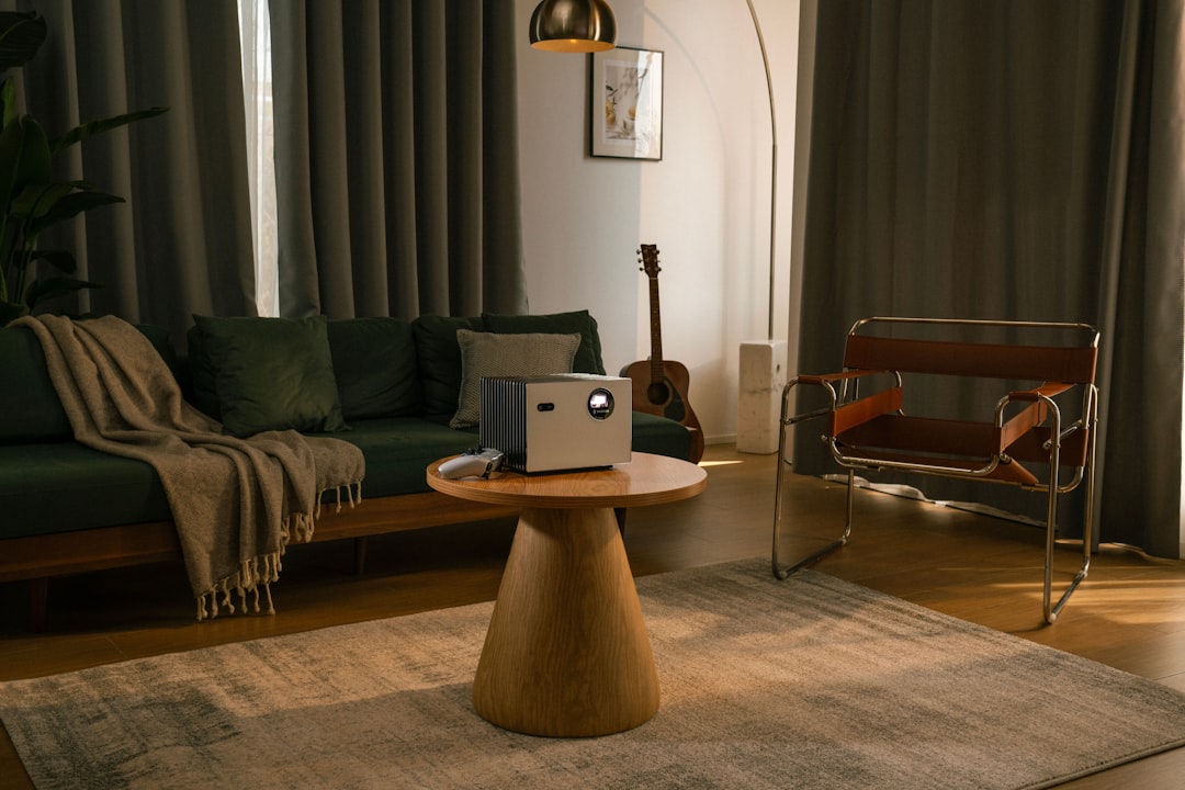 Savvy homeowner sits in their bright, modern living room, using a tablet to research efficient ways to sell their Indianap...