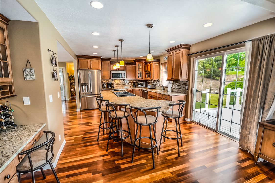 A beautiful, modern suburban home in the Midwest, likely Indianapolis, with a manicured green lawn under a bright, sunny sky, representing a valuable real estate asset.
