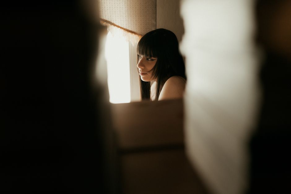 Focused, close-up view through a keyhole revealing a blurred but stylish modern home interior, symbolizing the opaque 'bla...