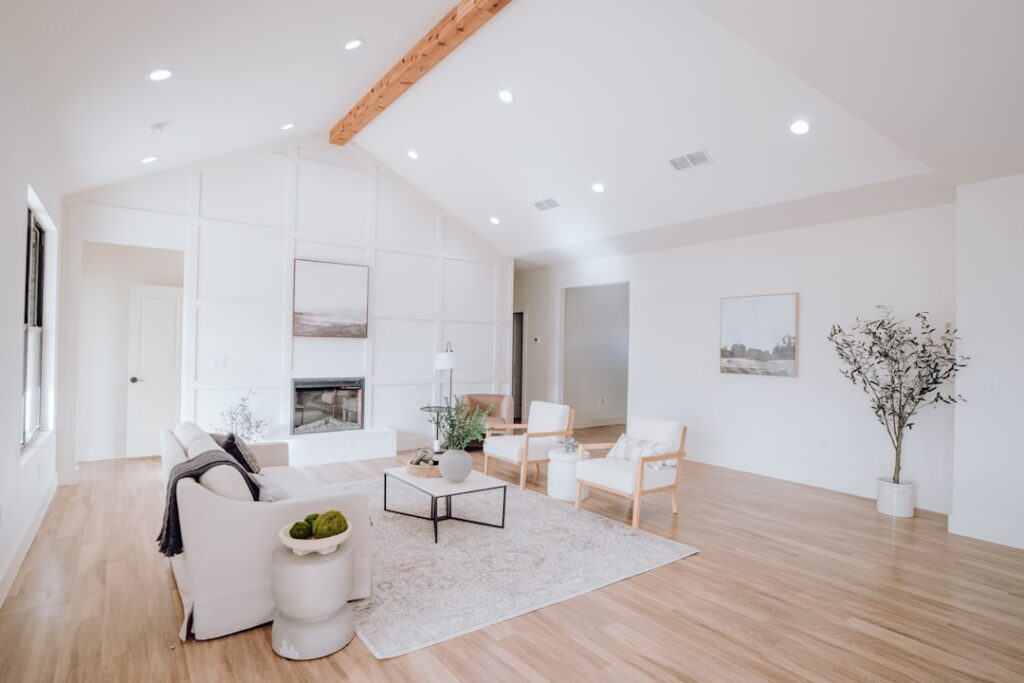 Homeowner and a real estate agent having a professional discussion at a table in a bright, modern home, representing the R...