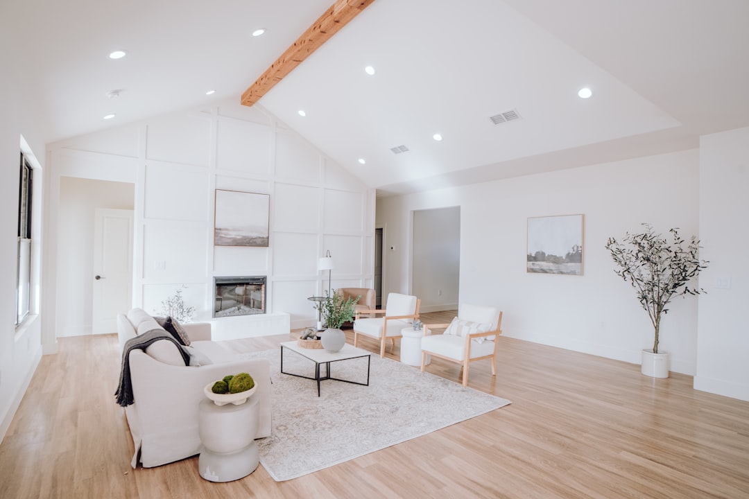 Homeowner and a real estate agent having a professional discussion at a table in a bright, modern home, representing the R...