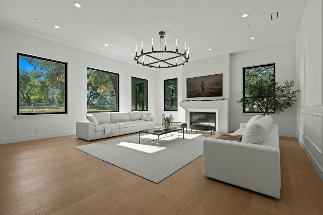 A professionally photographed, bright and modern living room with clean lines and stylish furniture, representing a perfect online real estate listing.