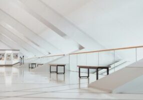 Bright, professional photo of a modern architectural blueprint for a home laid out on a clean desk, symbolizing a well-pla...