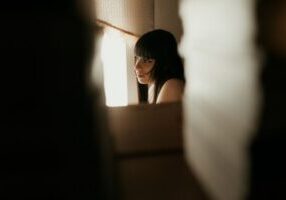 Focused, close-up view through a keyhole revealing a blurred but stylish modern home interior, symbolizing the opaque 'bla...