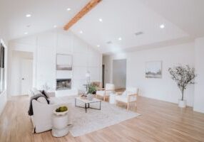 Homeowner and a real estate agent having a professional discussion at a table in a bright, modern home, representing the R...