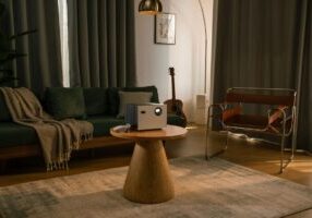 Savvy homeowner sits in their bright, modern living room, using a tablet to research efficient ways to sell their Indianap...
