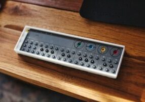 Sleek, modern calculator and a set of house keys resting on a clean, bright desk, symbolizing the smart financial calculat...